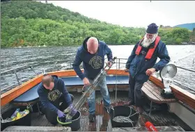  ?? ANDY BUCHANAN / AGENCE FRANCE-PRESSE ?? Professor Neil Gemmell (center) takes samples on his boat as he conducts research into the DNA present in the waters of Loch Ness in the Scottish Highlands on June 11.