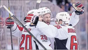  ?? CP PHOTO ?? Washington Capitals centre Lars Eller (20) celebrates his goal with teammates Tom Wilson (43) and Andre Burakovsky (65) during first period NHL hockey round one playoff action against the Toronto Maple Leafs, in Toronto on Wednesday.