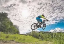  ?? Dave Kozlowski, provided by Crested Butte Mountain Resort ?? A mountain biker flies over the trail at Evolution Bike Park at Crested Butte.