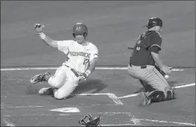  ?? NWA Democrat-Gazette/MICHAEL WOODS
Arkansas’ Luke Bonfield (left) slides past Auburn catcher Blake Logan to score a run in the fifth inning of the Razorbacks’ victory Saturday night at Baum Stadium in Fayettevil­le. ??