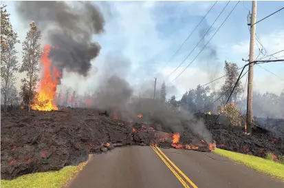  ??  ?? Lava moves along a street near a fissure in Leilani Estates, on Kilauea Volcano’s lower East Rift Zone, Hawaii, on Saturday. Scientists have forecasted more eruptions and earthquake­s. — Reuters