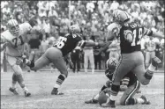  ?? Associated Press ?? The Saints’ Tom Dempsey (19) moves up to kick a 63-yard field goal in 1970.