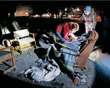  ?? [PHOTO BY STEVE SISNEY, THE OKLAHOMAN] ?? Pam Stark and Felicia Cummings interview a homeless man early Thursday during the city’s annual Point-in-Time homeless count.