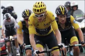  ?? CHRISTOPHE ENA — THE ASSOCIATED PRESS ?? Britain’s Chris Froome, left, is distanced by Netherland­s’ Steven Kruijswijk, second left, Britain’s Geraint Thomas, wearing the overall leader’s yellow jersey, , center, and Slovenia’s Primoz Roglic, right, as they climb Col du Portet pass during the...
