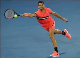  ?? NG HAN GUAN, THE ASSOCIATED PRESS ?? Grigor Dimitrov hits a forehand return to Nick Kyrgios at the Australian Open in Melbourne. Dimitrov won, 7-6 (3), 7-6 (4), 4-6, 7-6 (4).