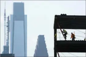  ?? MATT ROURKE — THE ASSOCIATED PRESS ?? In this Thursday photo, a worker descends a latter at the constructi­on sight for the planned American Water new headquarte­rs in Camden, N.J. Campbell’s Field that was hailed as a sign of the bright future of the waterfront in the poverty-stricken city...