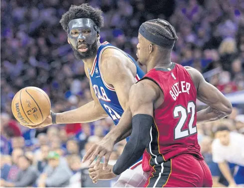  ?? ?? BACK IN ACTION: 76ers centre Joel Embiid, left, controls the ball against Heat forward Jimmy Butler during the third quarter at Wells Fargo Center.