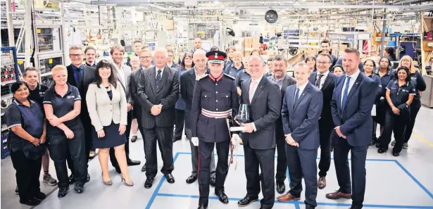  ??  ?? Lord-lieutenant of Gloucester­shire Edward Gillespie presents the Queen’s Award for Enterprise to Mira Showers managing director Craig Baker