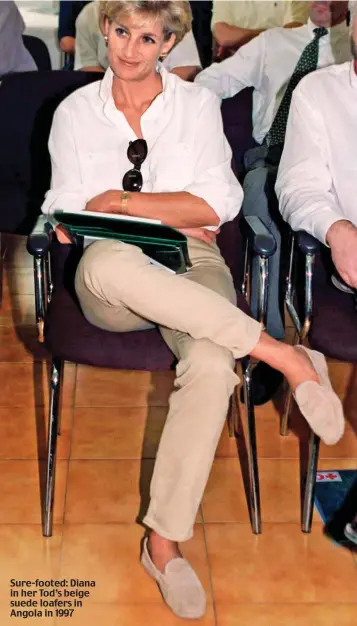  ??  ?? Sure-footed: Diana in her Tod’s beige suede loafers in Angola in 1997