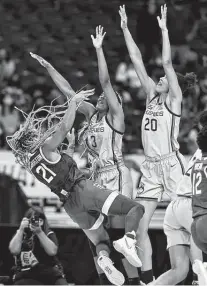  ?? Elsa / Getty Images ?? Baylor’s Dijonai Carrington tumbles to the floor after absorbing contact from Aaliyah Edwards, left, and Olivia Nelsonodod­a on the last-second play where no foul was whistled.