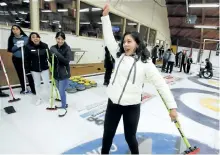  ?? CLIFFORD SKARSTEDT/EXAMINER ?? Paola Salgado, 19, reacts to her first time curling as a group of 50 Mexican students studying ESL at Trent University of the Canada Homestay Network and their host parents had the opportunit­y to try curling with a one hour Learn to Curl session...