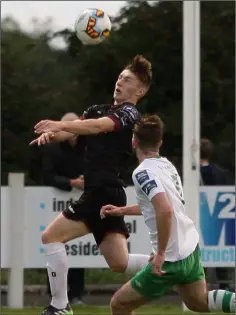  ??  ?? Danny Doyle uses his head to get the better of defender Roy McGee.