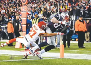  ??  ?? Patriots tight end Rob Gronkowski makes his second touchdown reception during Saturday’s playoff game against the Chiefs. Gronkowski finished with seven catches for 83 yards. Jim Rogash, Getty Images