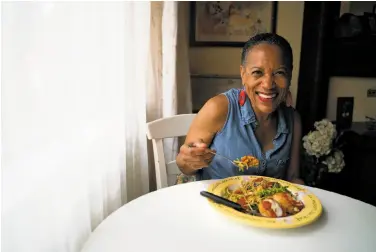  ?? Photos by Sarahbeth Maney / Special to The Chronicle ?? Left: Renee McGhee prepares a meal in the kitchen in Berkeley. Above: McGhee, 62, tastes her homemade dish: spinach pasta with eggplant parmesan. Home-cooked meals helped pay her rent.