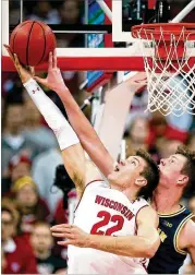  ?? DYLAN BUELL / GETTY IMAGES ?? Wisconsin’s Ethan Happ (22) fifinished with 26 points and 10 rebounds as his Badgers upset second-ranked Michigan 64-54 on Saturday.