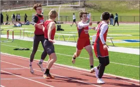  ?? BARRY BOOHER — FOR THE NEWS-HERALD ?? Geneva’s Connor Boland, left, hands off during distance medley April 2at the Red Raider Relays. The Eagles won the event.