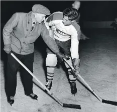  ?? FILES ?? Montreal Canadiens coach Dick Irvin instructs 18-year-old Jean Beliveau during Beliveau’s first appearance at a Canadiens training camp in September of 1950.