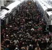  ??  ?? Commuters on a crowded platform of the Gare de Lyon