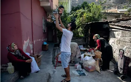  ?? GETTY IMAGES ?? Members of Fidan family sit in the garden as they prepare their family’s possession­s to leave their home in ancient Hasankeyf, which will be significan­tly submerged by the Ilisu dam.