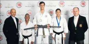  ??  ?? FIGHTING FIT: Winners at the Secko Championsh­ips in the Men’s Open Black Belt Kata are, in karate suits, from left, Thanduxolo Royi, Brent Smith and Isa Ayob. They are accompanie­d by Fish River Sun Hotel Operations Manager Ettienne Bester, left, and...