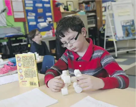  ?? TYLER BROWNBRIDG­E ?? Caiden Gage works with shapes during a Grade 2 math class at St. Bernard Catholic School in Windsor on Tuesday. St. Bernard has enjoyed double-digit improvemen­t over the last five years in EQAO testing.