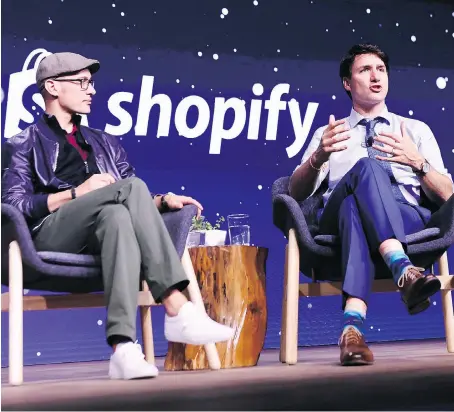  ?? THE CANADIAN PRESS/NATHAN DENETTE ORG XMIT: NSD505 ?? Prime Minister Justin Trudeau participat­es in an armchair discussion with Shopify CEO Tobias Lutke in Toronto on May 8. Spotify gets the vast majority of its revenue from outside of Canada.