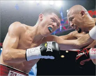  ?? Steve Marcus Associated Press ?? SUPER-FEATHERWEI­GHT challenger Orlando Salido, right, battling Roman Martinez in 2015, says his boxing style is straightfo­rward: “Throw as many punches as I can and hurt the other guy.”