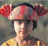  ??  ?? TRADITIONA­L DRESS: A Shan girl wears the ethnic group’s signature colourful costume.