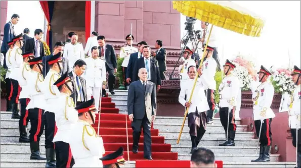  ?? PHA LINA ?? King Norodom Sihamoni descends the steps of Independen­ce Monument on Sunday after a ceremony to extinguish the victory flame lit on Friday to celebrate the 65th anniversar­y of Cambodia’s independen­ce from France in 1953.