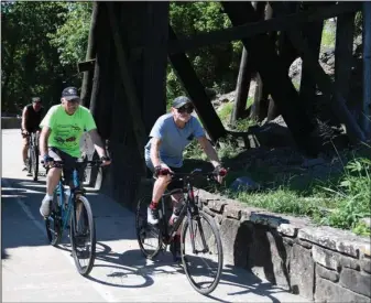  ?? The Sentinel-Record/Grace Brown ?? GROUP RIDE: Bicyclists make their way down the Hot Springs Creek Greenway Trail on Wednesday. Outdoor activities are part of what draws millions of visitors to Garland County each year, according to a new report.