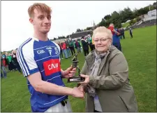  ??  ?? Minor Man of the Match award sponsor Mrs Price presents Eire Óg’s Conor Fulham with his award after the final in Pearse’s Park.