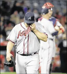  ?? CHRIS CARLSON / AP ?? Veteran right-hander Bartolo Colon exits Tuesday’s game against the Angels in the third inning after allowing nine runs, seven of them unearned.