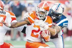  ?? GRAHAM HUGHES/CANADIAN PRESS ?? Montreal Alouettes defensive end Gabriel Knapton tackles B.C. Lions running back Jeremiah Johnson during the first half in Montreal on Thursday. The Lions won 23-16.