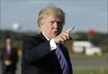  ?? EVAN VUCCI — THE ASSOCIATED PRESS ?? President Donald Trump gestures as he walks to board Air Force One to travel to Huntsville, Ala., for a campaign rally for Senate candidate Luther Strange, Friday in Morristown, N.J.