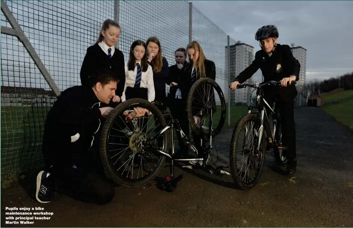  ??  ?? Pupils enjoy a bike maintenanc­e workshop with principal teacher Martin Walker