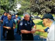  ?? DAN SOKIL — DIGITAL FIRST MEDIA ?? World War II veteran Harry Snyder of Upper Gwynedd shakes hands with Lansdale Police Chief Mike Trail after Trail thanked Snyder for his service.