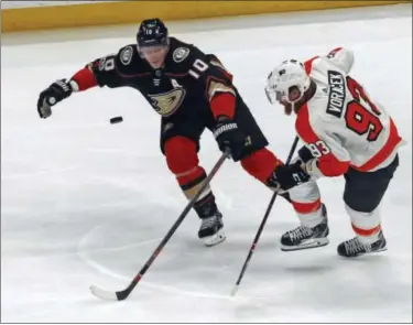  ?? REED SAXON — THE ASSOCIATED PRESS ?? Flyers winger Jake Voracek, right, and Anaheim Ducks right winger Corey Perry do a little puck racing last Saturday night in Anaheim.