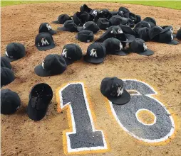  ?? (Reuters) ?? THE HATS of all the Miami Marlins lay on the pitcher’s mound after Monday night’s 7-3 home victory over the New York Mets to honor their late teammate, starting pitcher Jose Fernandez, who died on Sunday at the age of 24 in a boating accident.