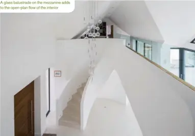  ??  ?? A glass balustrade on the mezzanine adds to the open-plan flow of the interior