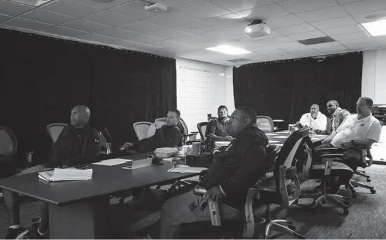  ?? MARYLAND ATHLETICS PHOTOS ?? Maryland coach Mike Locksley, wearing a white sweatshirt at the far end of the table, and his offensive coaches meet at the Gossett Team House on Tuesday of game week.