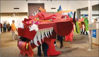  ?? Submitted photo ?? NOON YEAR’S EVE: A cardboard dragon parades through Mid-America Science Museum Dec. 29 as part of the museum’s annual Noon Year’s Eve party. During the celebratio­n the first-place award for the inaugural Dino-Lites display was given to Hale Entertainm­ent.