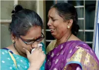 ?? — AFP ?? Relatives of victims injured stampede on a railway bridge cry as they wait at a hospital in Mumbai