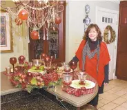  ?? DAVID GARRETT/ SPECIAL TO THE CALL ?? Bethlehem GardenClub member Anne Chiadis with a display of hand-blown glass in her home, one of six on the club's ‘Artful Christmas' house tour Dec. 9.