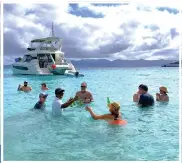  ?? ?? In the British Virgin Islands, a server redefines the swim-up bar for thirsty passengers of Emerald Cruises' Sakara, a 100-guest yacht on its maiden voyage.