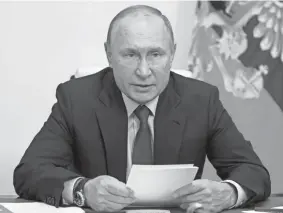  ?? ALEXEI DRUZHININ/SPUTNIK, KREMLIN POOL PHOTO VIA AP, FILE ?? Russian President Vladimir Putin, pictured here, is one of 330 current and former politician­s identified as beneficiaries of the secret accounts.