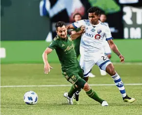  ??  ?? I got it: Portland Timbers’ Sebastian Blanco (left) vying for the ball with Montreal Impact’s Shamit Shome during the Major League Soccer match in Portland on Saturday. — AP