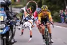  ??  ?? Julian Alaphilipp­e falls after crashing into a motorbike, as he rides behind Wout van Aert (front) and Mathieu van der Poel. Photograph: BELGA/AFP/Getty Images