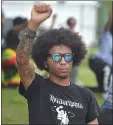  ?? PETE BANNAN - MEDIANEWS GROUP ?? A Black Lives Matters protester holds his fist up in front of the Glenolden Police Station.