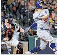  ?? AP/DAVID J. PHILLIP ?? Joc Pederson hits a three-run home run during the ninth inning of Game 4 of the World Series, helping the Dodgers to a 6-2 victory over the Astros on Saturday in Houston.