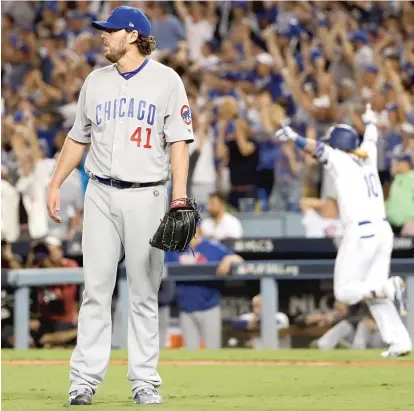 ?? | AP ?? John Lackey looks on after allowing the winning three- run homer to the Dodgers’ Justin Turner in the ninth inning Sunday.